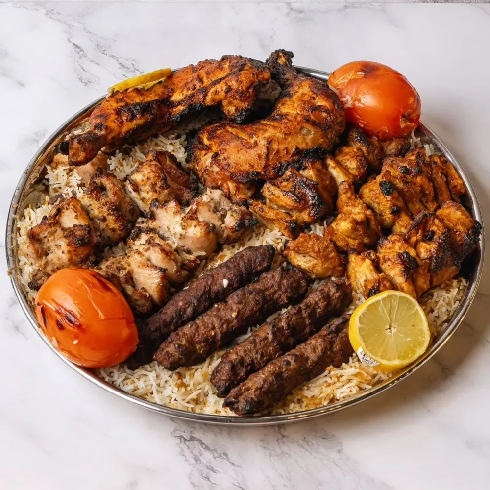 Mixed grill platter with seekh kabob, chicken tikka and kabobs over rice